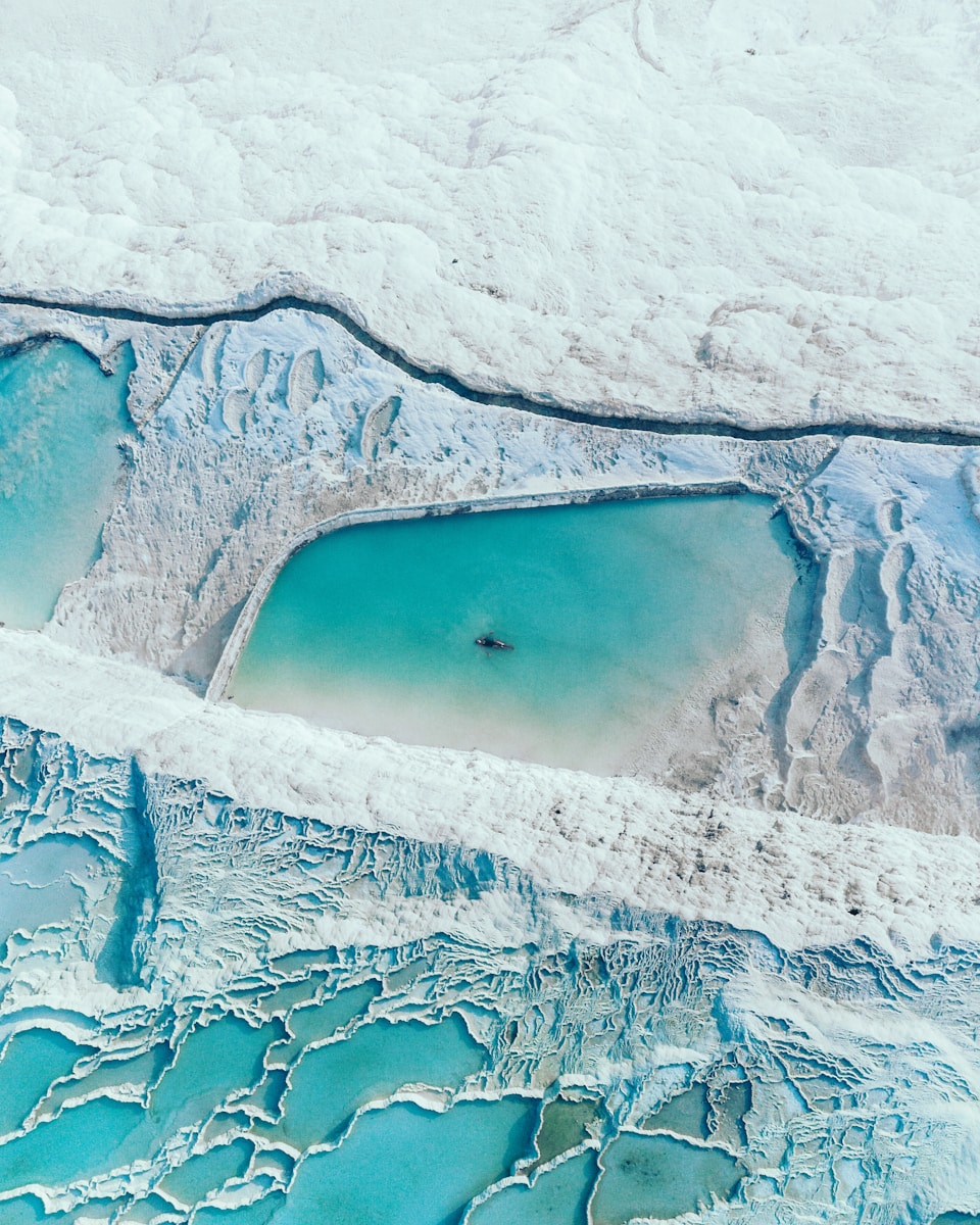 An aerial view of a glacier and a body of water